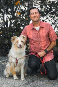 A man and his dog pose for the camera.